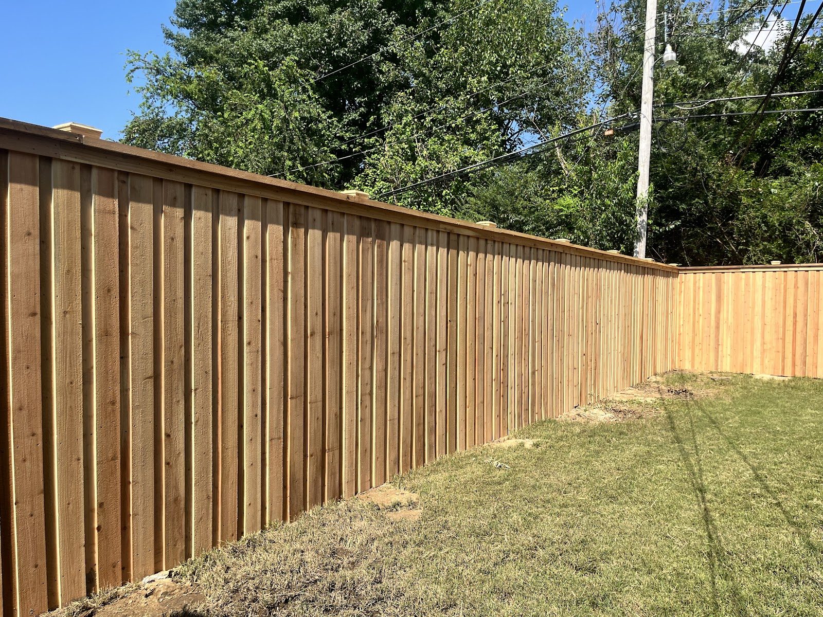 Long run of wood privacy fencing around a backyard